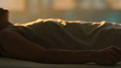 A person lying at rest under a blanket during a breathwork session