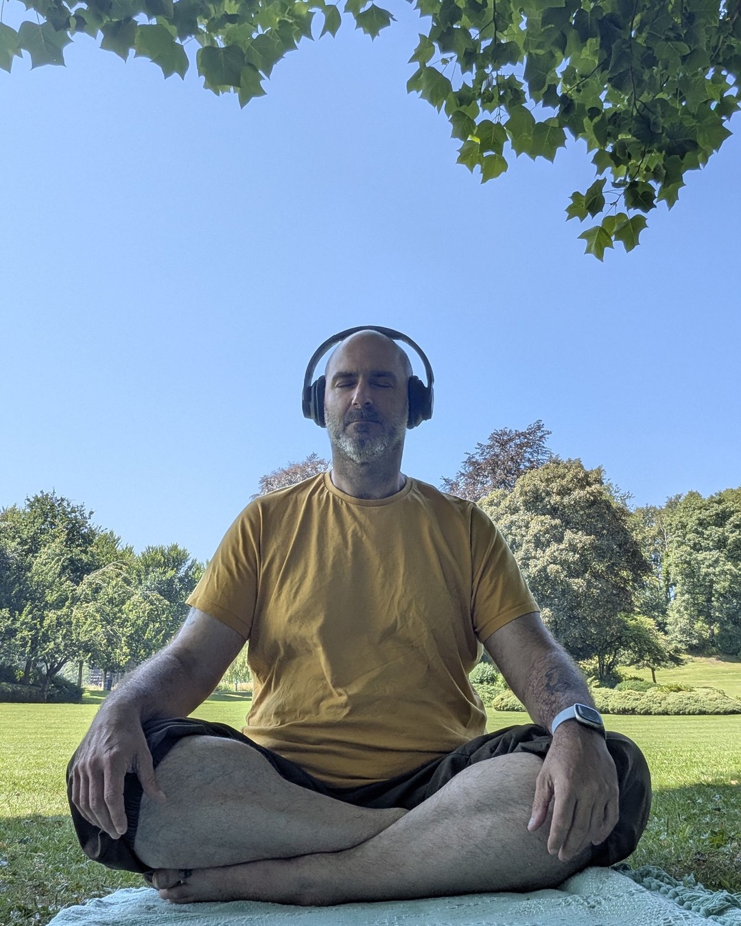 Richard Porter, who runs Unfrozen, sitting cross-legged on a mat in a park
